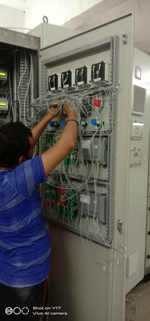 Engineer wiring an industrial automation control panel